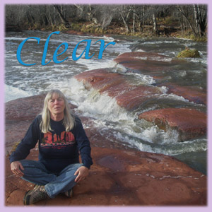 Sedona healer Cynthia Tierra sitting by the creek at Red Rock Crossing with the word clear over her head.