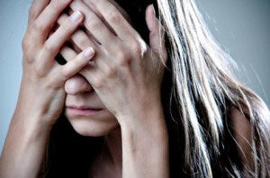 This image is of a woman who is suffering, with her hands covering her eyes