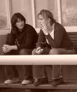 Two women sitting together and talking